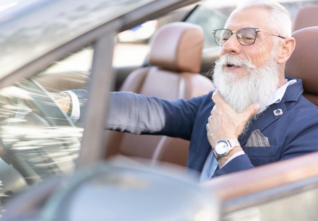 Senior business man driving a convertible car